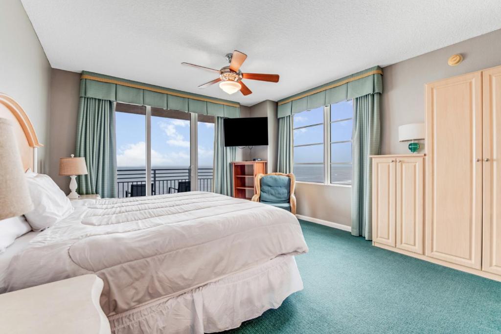 a bedroom with a bed and a ceiling fan at 10th Floor Oasis Stunning 2BR with Spacious Private Double Balcony at The Wyndahm Ocean Walk Resort in Daytona Beach