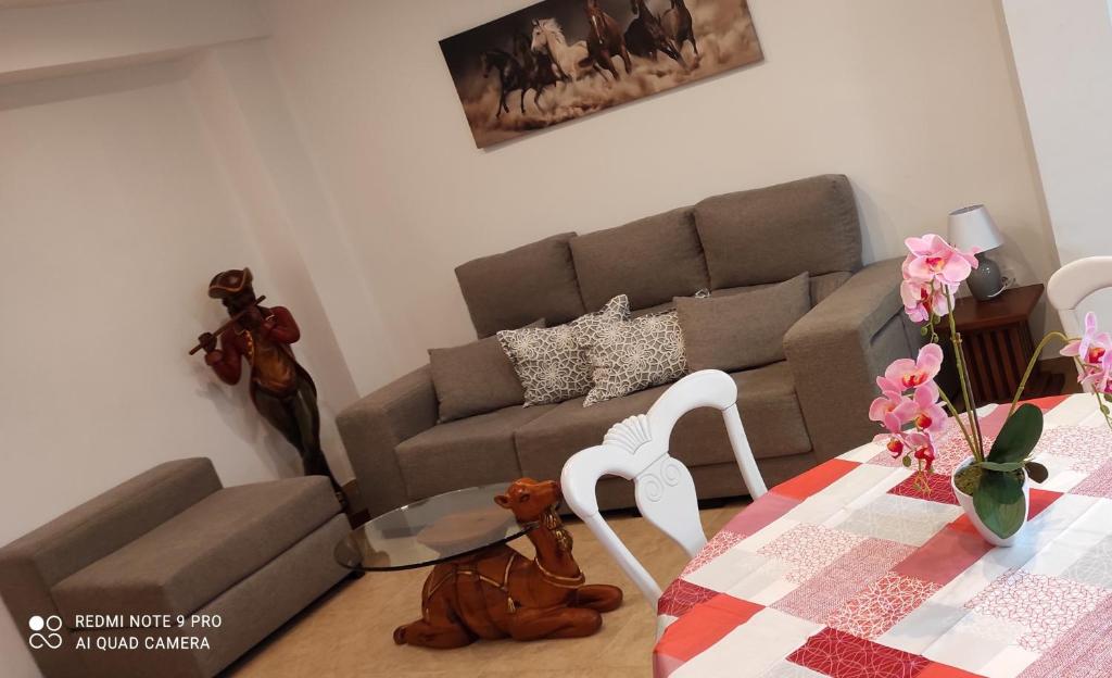 a living room with a couch and a table at TU CASA en Benetússer , VALENCIA in Benetúser