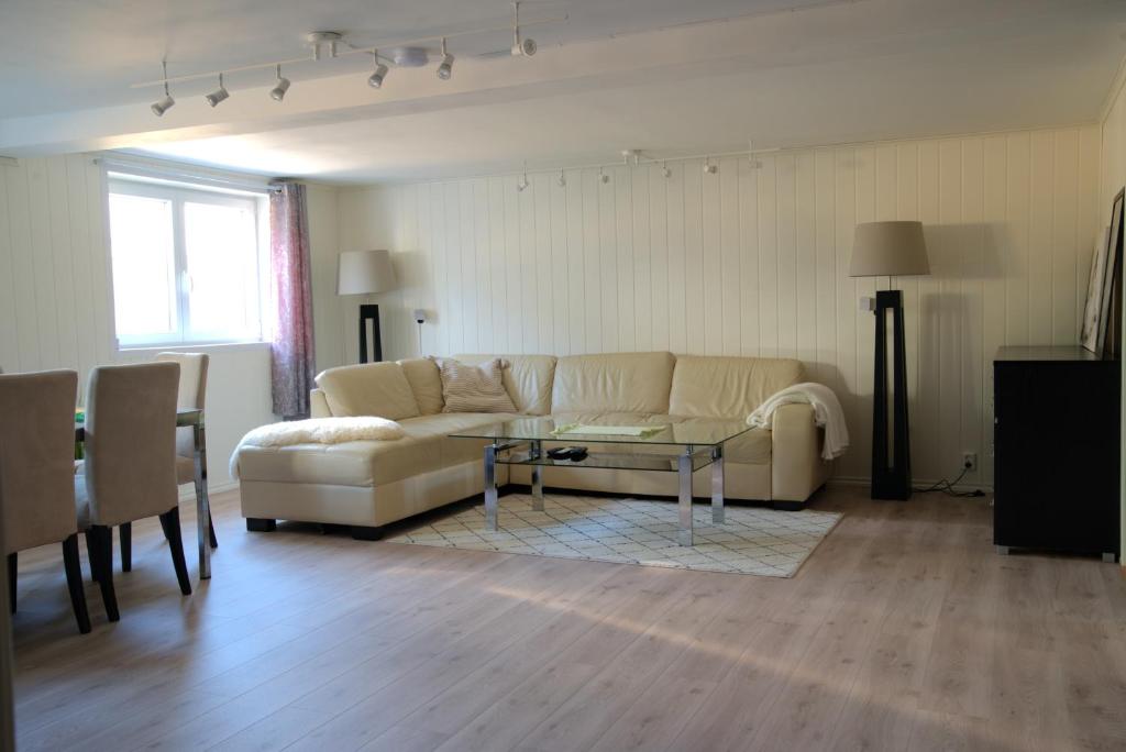 a living room with a couch and a table at Spacious apartment in Sarpsborg