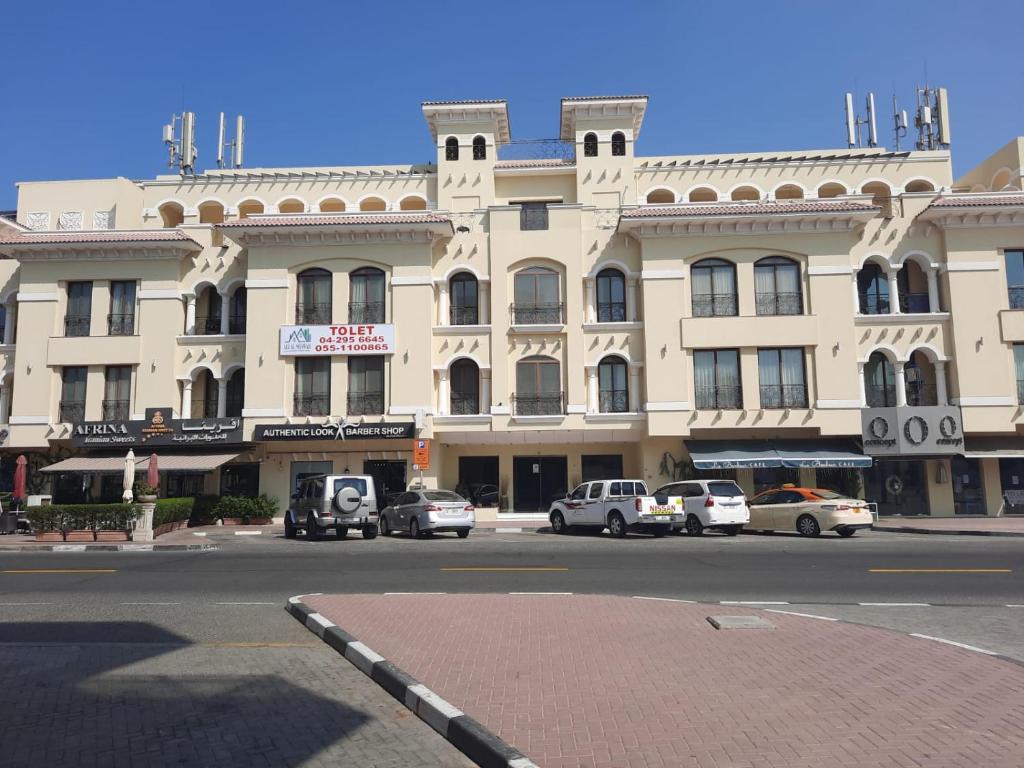 a large building with cars parked in front of it at 1Bedroom Furnished Apartment in Dubai