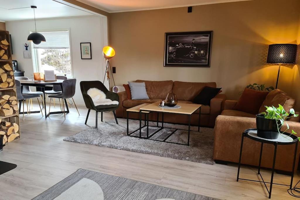 a living room with a couch and a table at Flott leilighet i Narvik med gratis parkering! in Narvik
