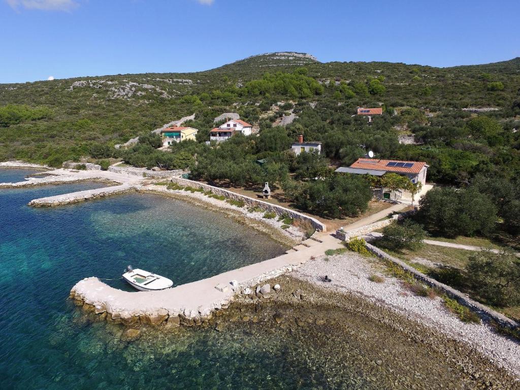 an island with a small boat in the water at House Marta in Kraj