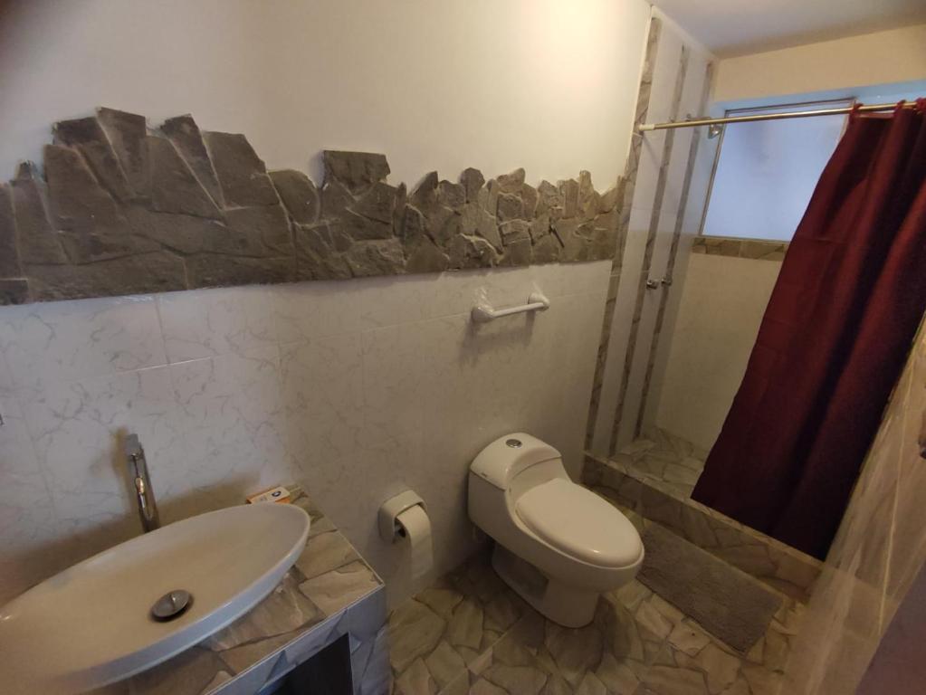 a bathroom with a toilet and a sink and a shower at Casa edad dorada in Calca