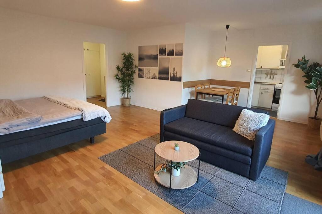 a living room with a couch and a table at Apartment with garden near metro! in Stockholm