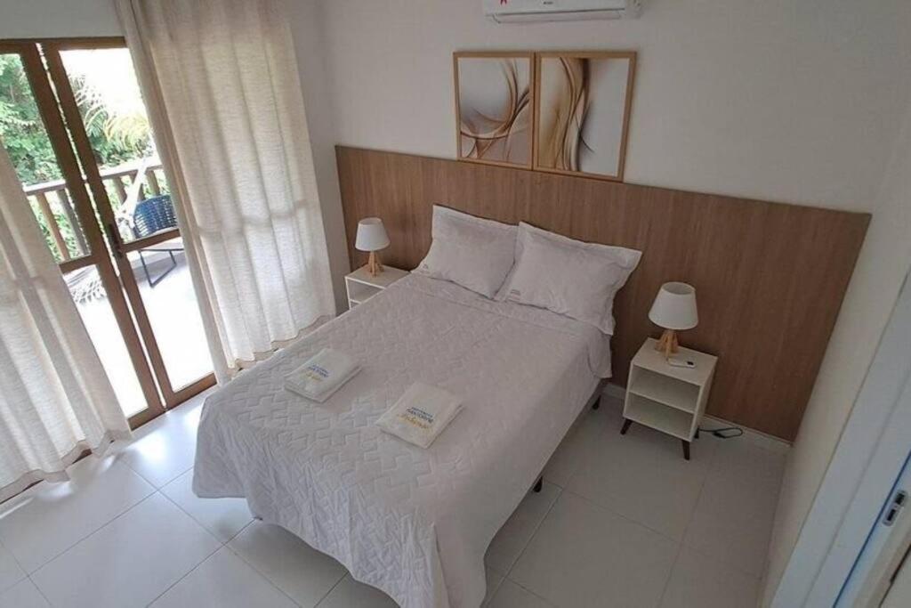 Krevet ili kreveti u jedinici u objektu Santorini imbassai,100 m praia menor preço