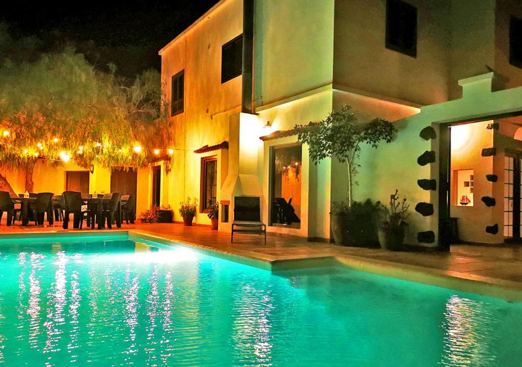 a swimming pool in front of a house at night at Casa-la-Costa in La Costa