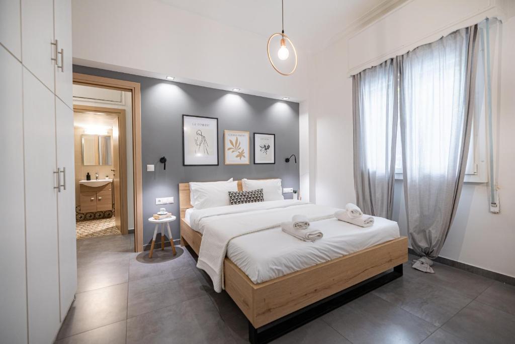 a bedroom with a large bed and a bathroom at Ports Crossroad C in Piraeus