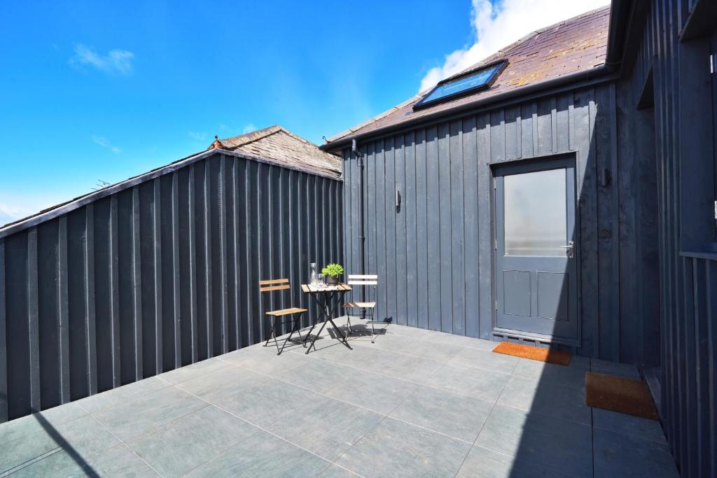 a patio with a table and chairs next to a building at Apt 1, 15 West Street in Hereford