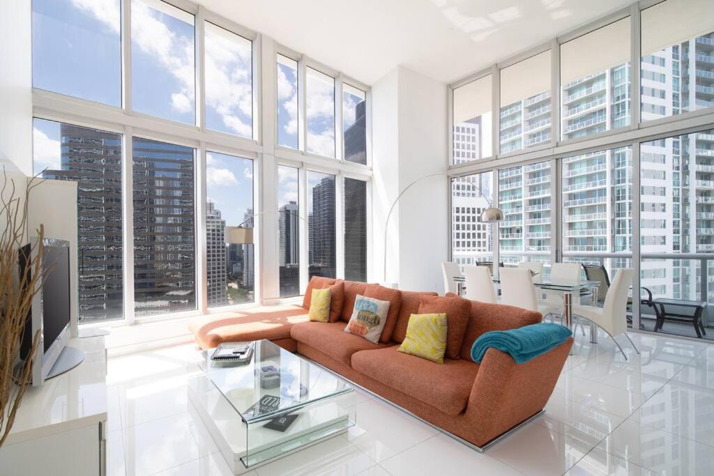 a living room with a couch and a glass table at Stunning Brickell Luxury Condo in Miami