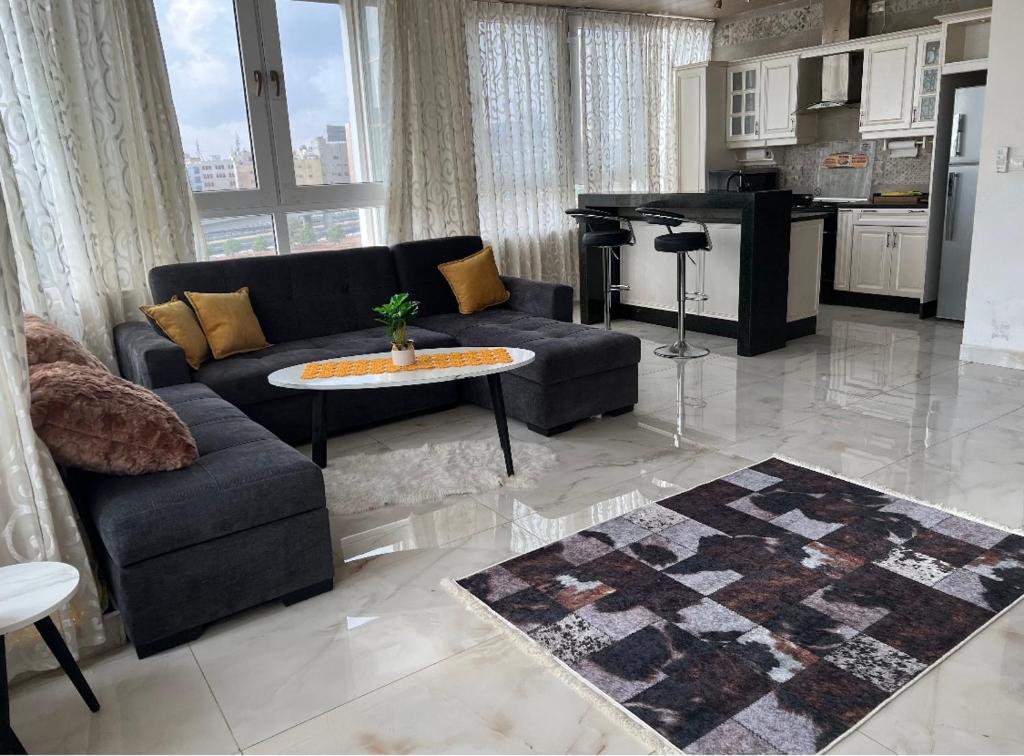 安曼的住宿－1BR-Deir Gbar rooftop，客厅配有沙发和桌子