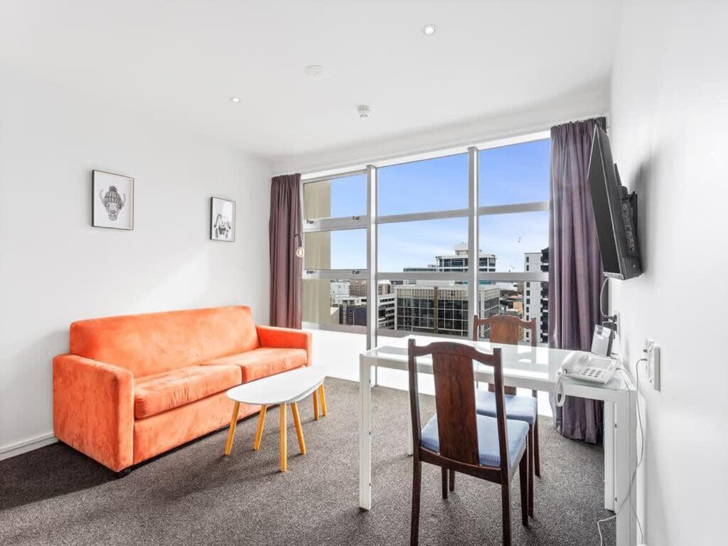 a living room with a couch and a table at Central City 1BR Apartment in Auckland