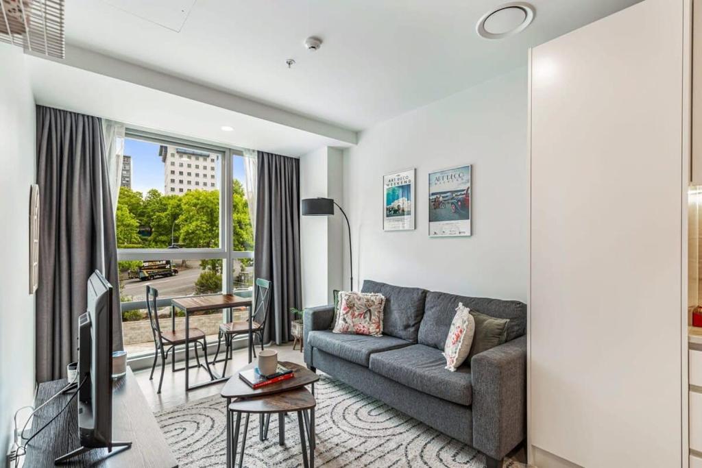 a living room with a couch and a table at At the cultural heart of Auckland CBD in Auckland