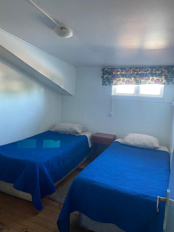 Voodi või voodid majutusasutuse HOSTAL VALDIVIA toas