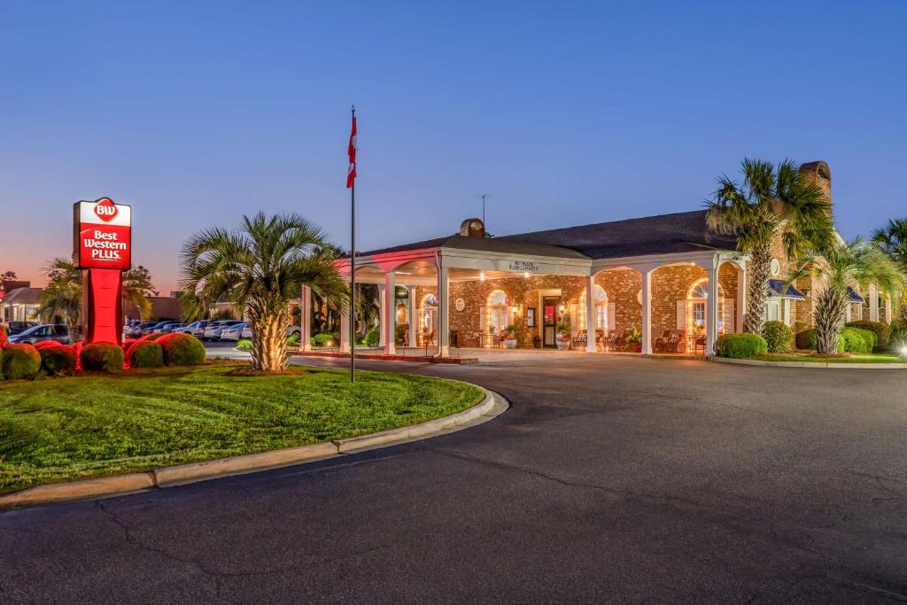 a hotel with a sign in front of a building at Best Western PLUS Santee Inn in Santee