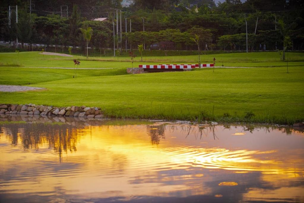 a view of a golf course with a pond at URBAN VIBER MOTEL in Kigali