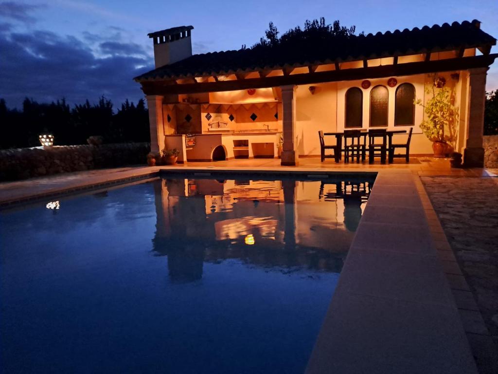 a house with a swimming pool at night at Son Pujol in Las Ollerías