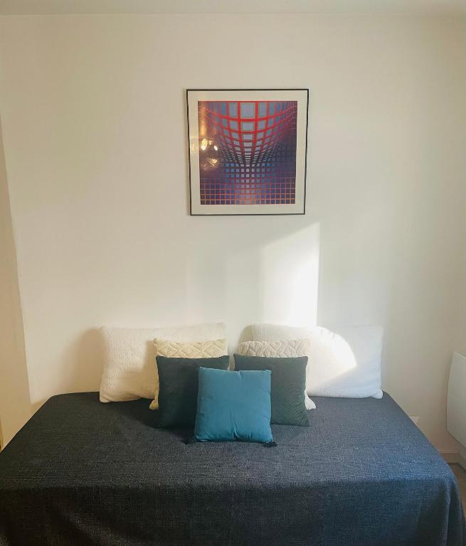 a bedroom with a bed with a picture on the wall at 45 m2 private apartment in Paris in Paris