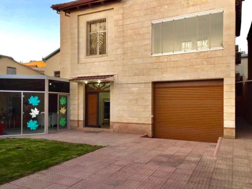 een huis met een garagedeur ervoor bij Luxury villa 8 bedrooms in Baku