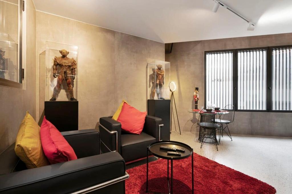 a living room with a black couch and a red rug at New York style Loft in Sydney