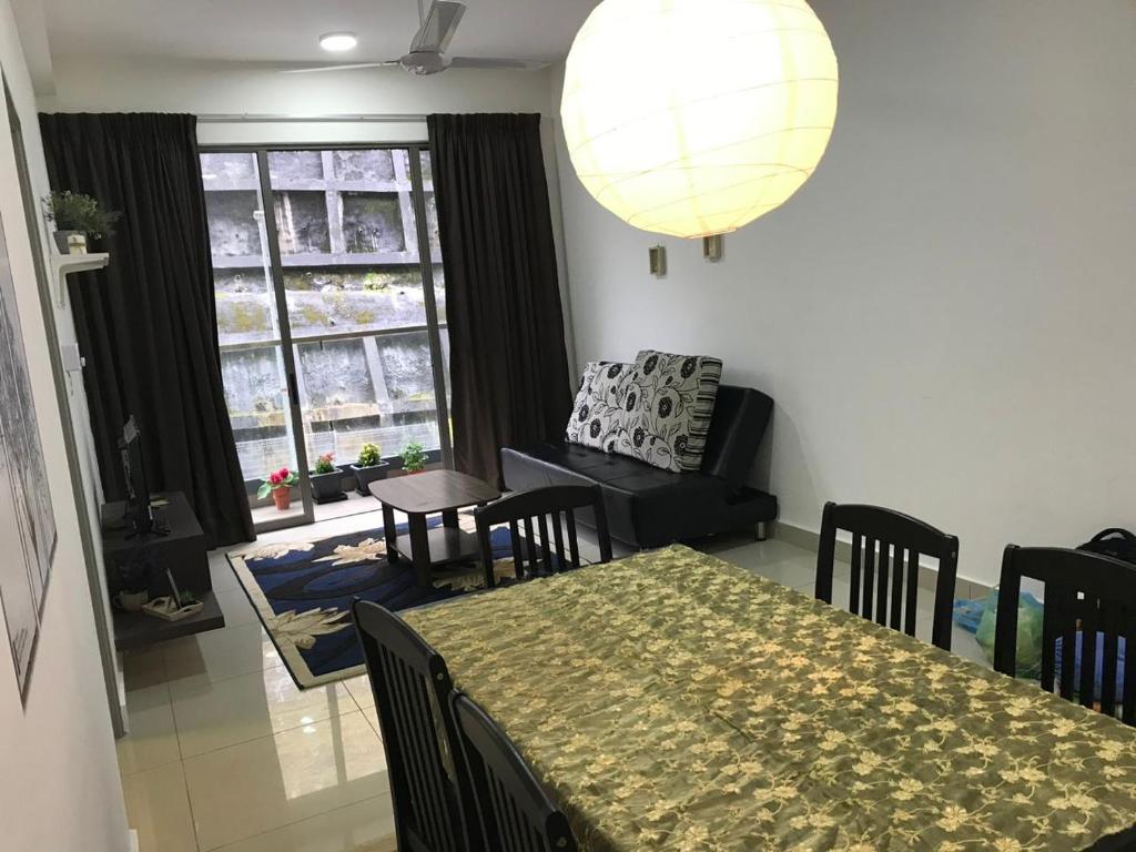 a dining room with a table and chairs and a room with a window at Palas Horizon Mist in Cameron Highlands