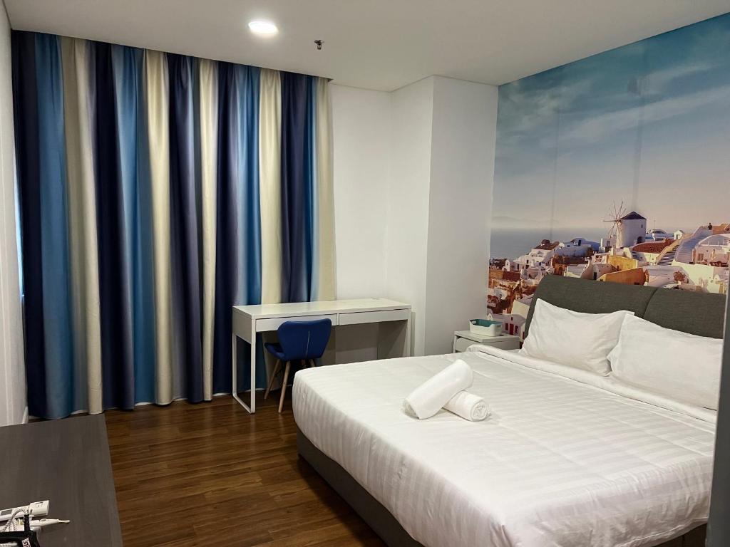 a bedroom with a bed and a desk in it at Summer Suites KLCCby Victoria in Kuala Lumpur