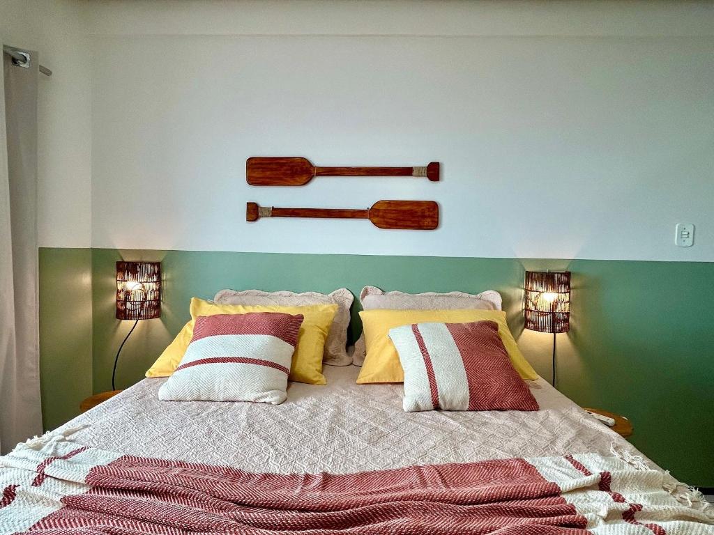 a bedroom with a large bed with two lamps at (106) Exclusivo Vista mar na praia da Litorânea in Pimenta