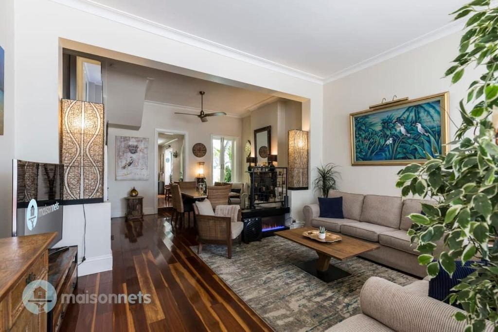 a living room with a couch and a table at 3 Bedroom House With Large Courtyard & City Views in Sydney