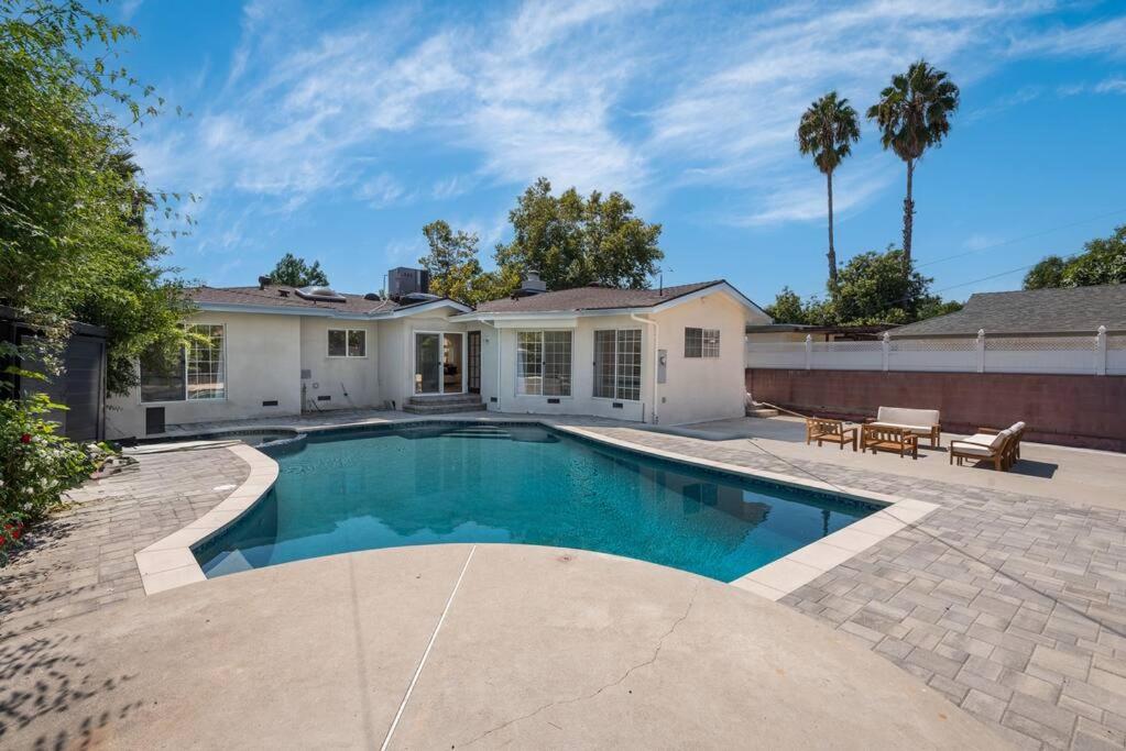 a swimming pool in the backyard of a house at Luxurious 4-Bedroom Home with Pool & Jacuzzi! in Los Angeles