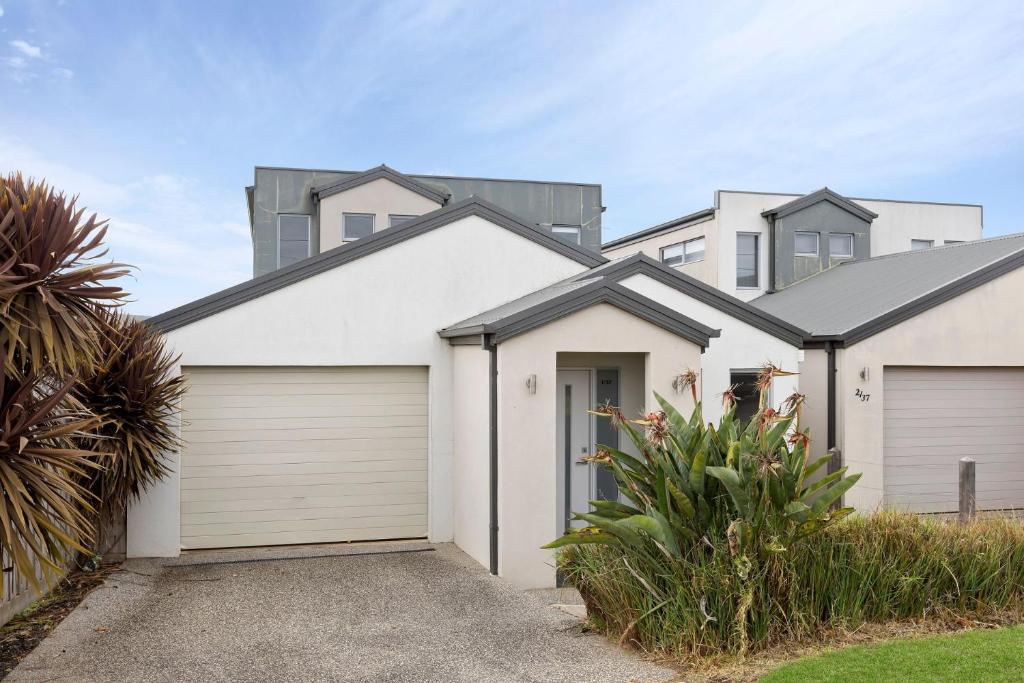 a white house with a garage at Port Views in Portarlington