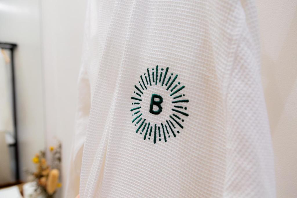 a white curtain with a letter b on it at Bahandi Hotel in General Luna