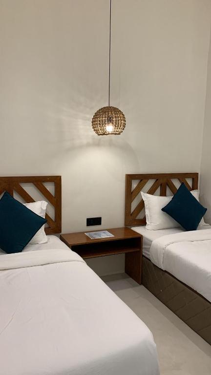 Postel nebo postele na pokoji v ubytování Bahandi Hotel