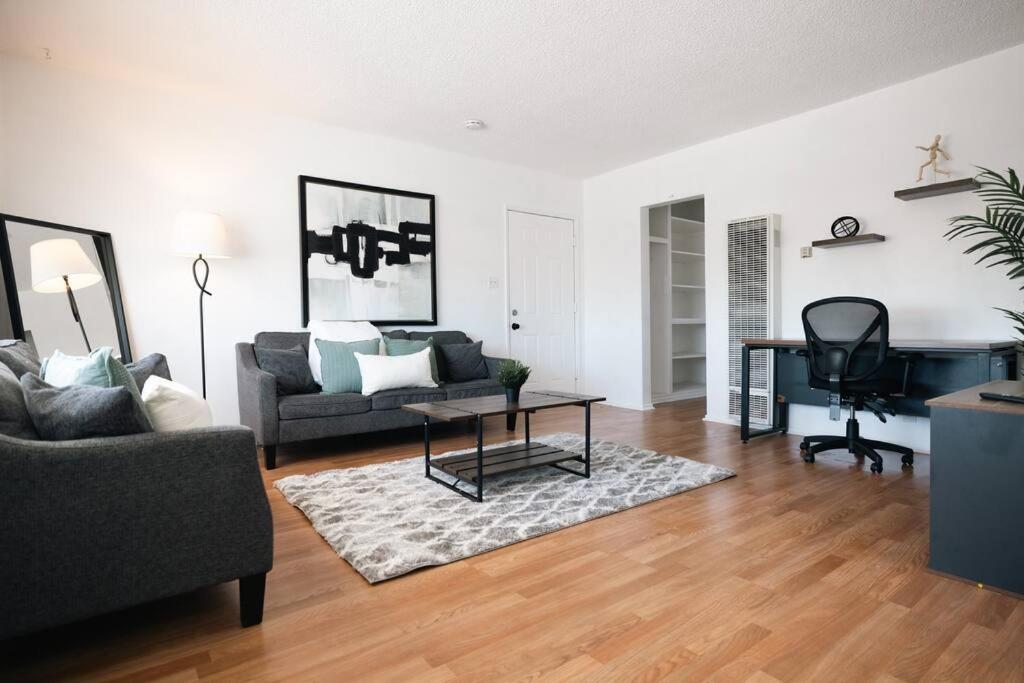 a living room with a couch and a desk at ModernHaven -SoFi, Forum, Intuit in Hawthorne