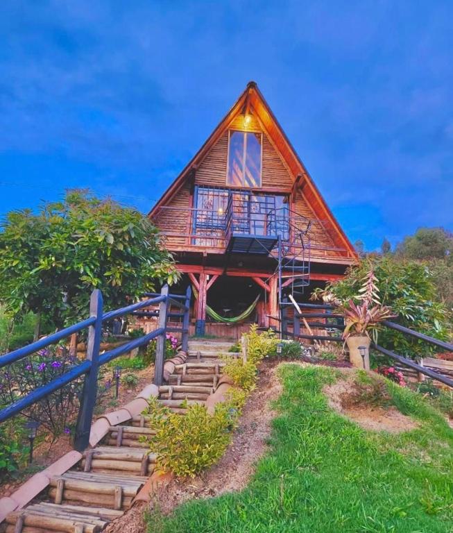 a house with stairs leading up to it at GLAMPING MILAGROS in San Pedro