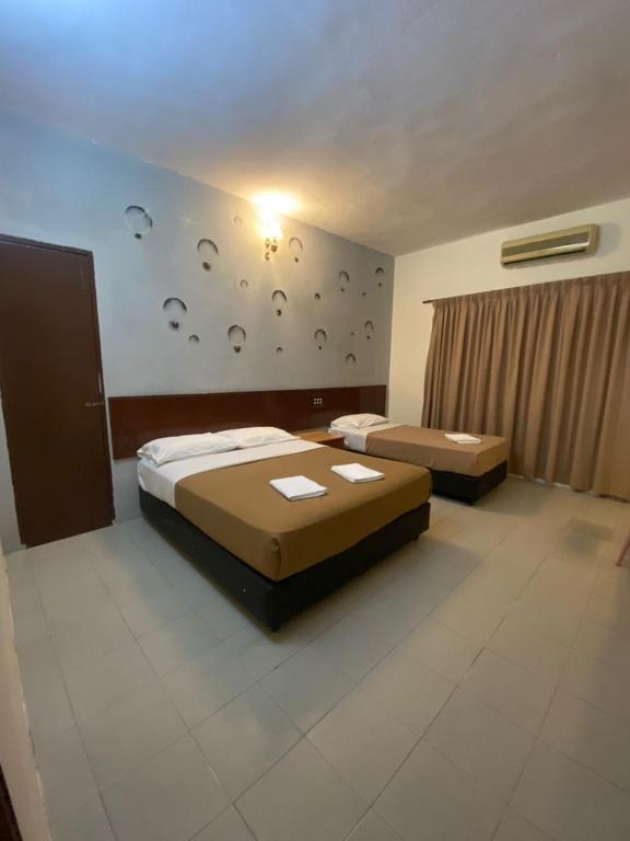 Postel nebo postele na pokoji v ubytování Pangkor Bay View Beach Resort