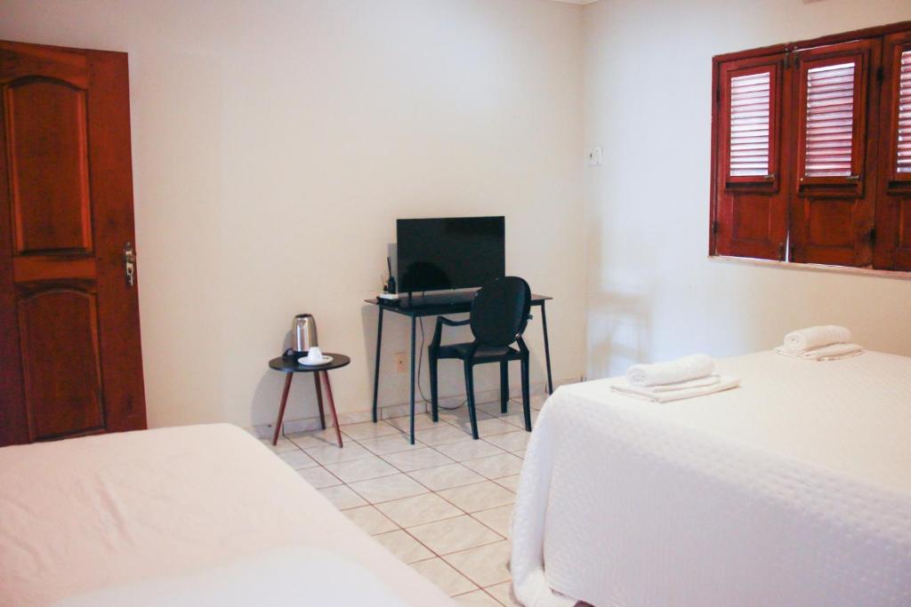 Postel nebo postele na pokoji v ubytování Rio Claro Comfort Hostel e Suítes