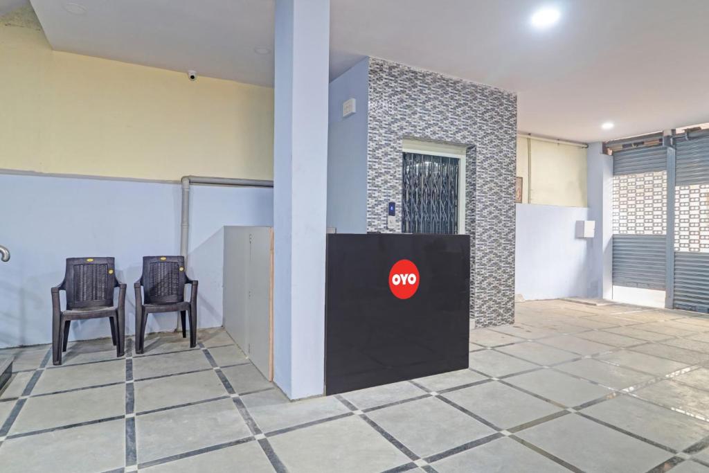 a lobby with two chairs and a stop sign on a wall at 80983G RBS Square Langer Houz in Haidar Sāhibgūda