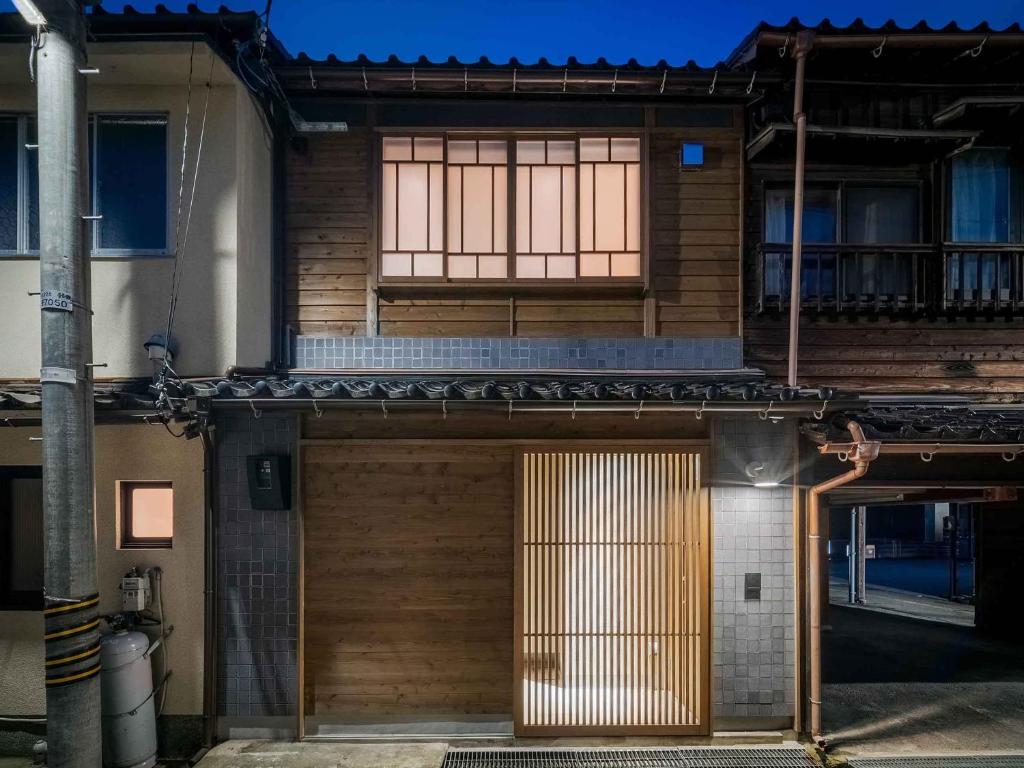 a house with a wooden door and a window at Tokikaze Machiya House in Kanazawa
