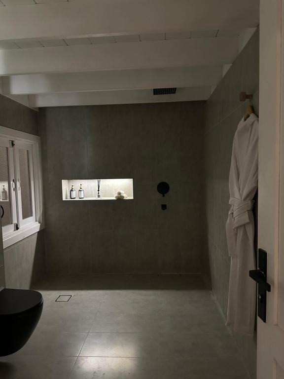a bathroom with a robe hanging on a wall at شاليه pali villa in Buraydah