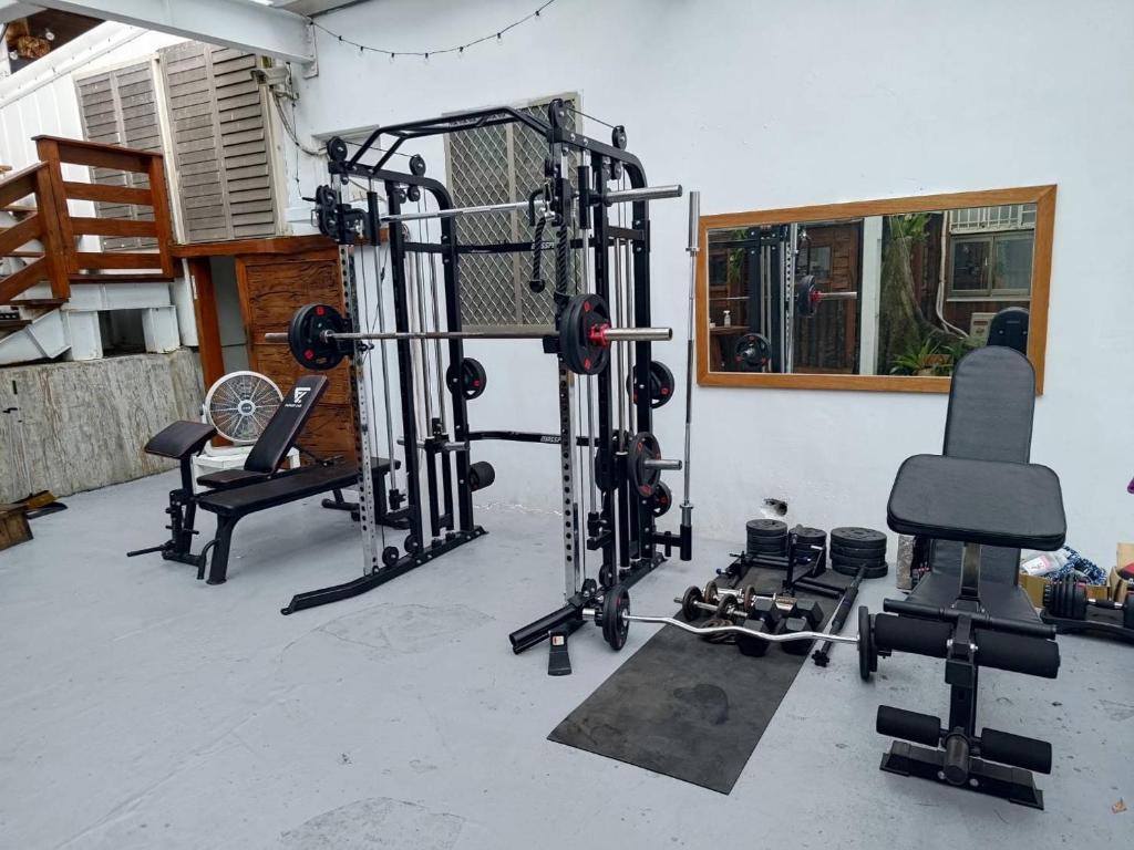 a fitness room with a gym with several equipment at Star-Moon B&amp;B Green Island in Green Island