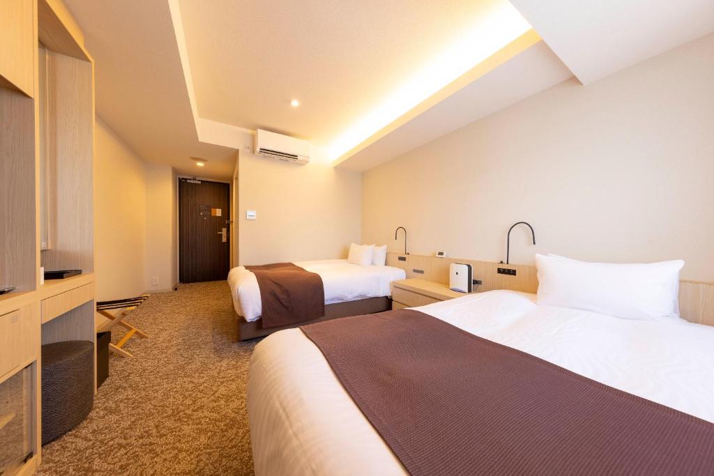 Postel nebo postele na pokoji v ubytování Hotel Granbinario Tsuruga