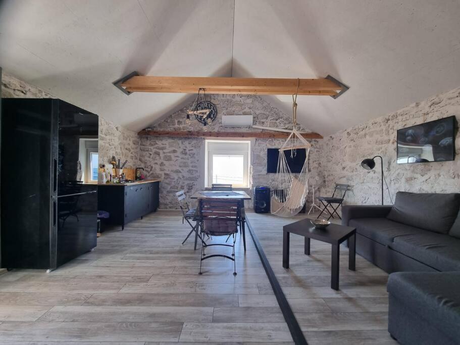 a living room with a couch and a table at Vila Kyra in Rtina