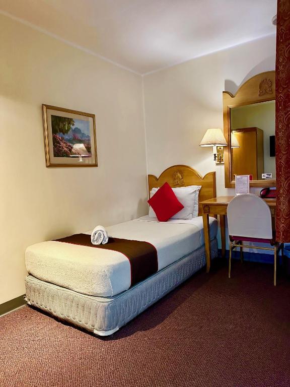 Postel nebo postele na pokoji v ubytování Palladium Suites Hotel