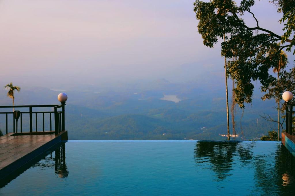 a view of the water from a resort infinity pool at Mistil Garden Resort in Kozhikode