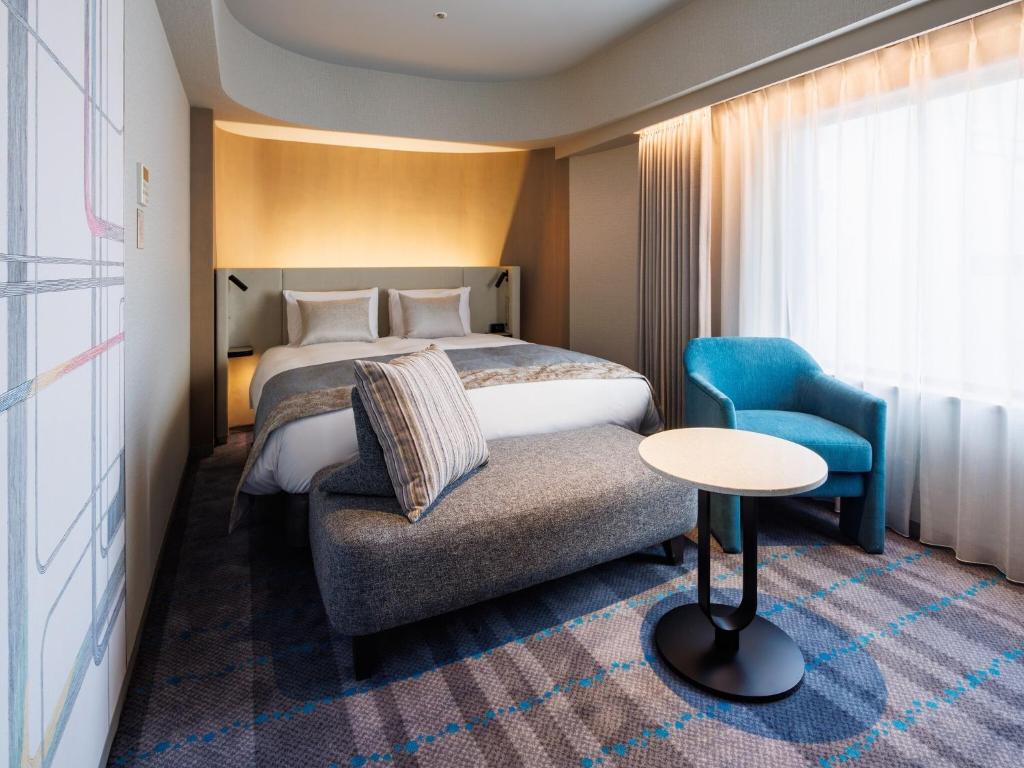 Postel nebo postele na pokoji v ubytování Hotel Metropolitan Tokyo Ikebukuro