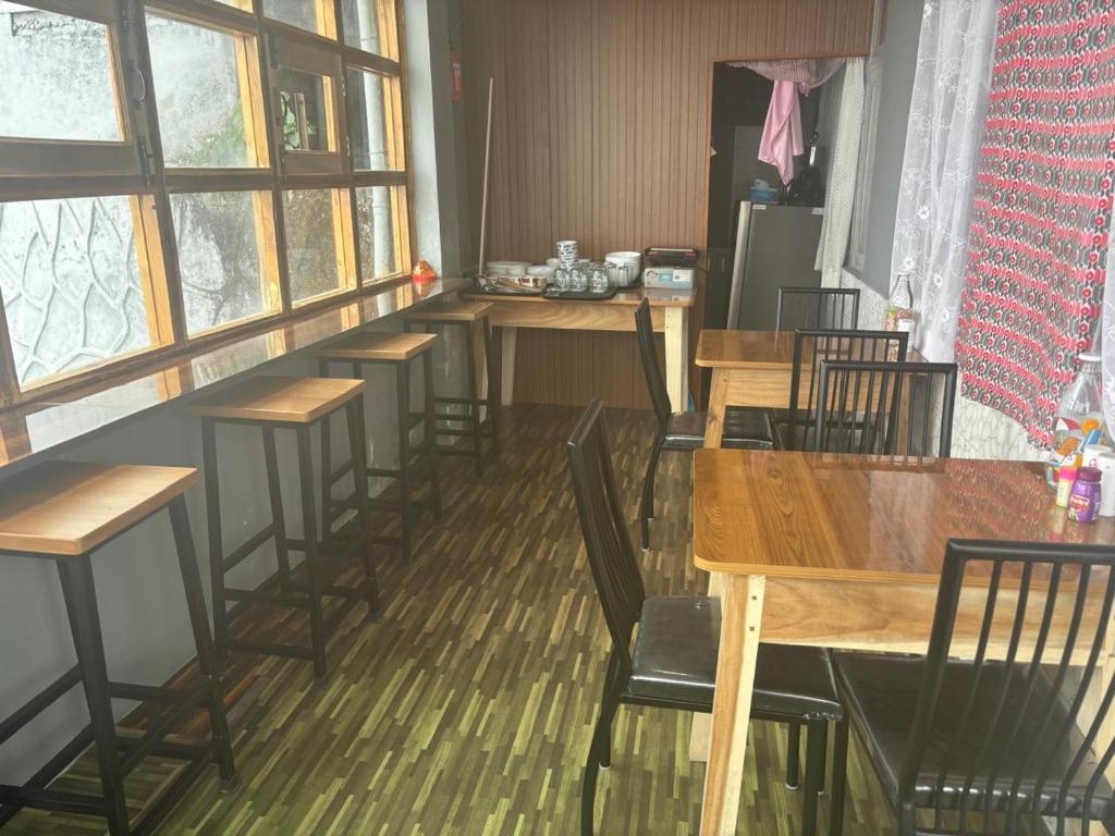 a row of tables and chairs in a restaurant at The Valaya Hotel in Darjeeling