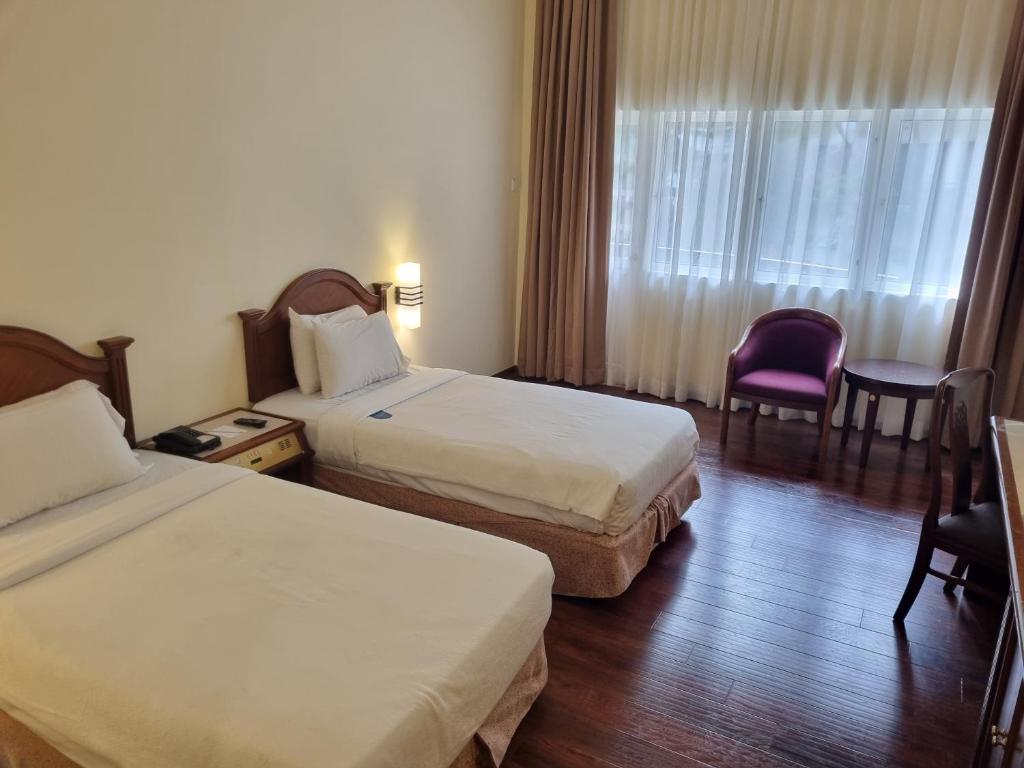 Postel nebo postele na pokoji v ubytování Heritage Hotel Cameron Highlands