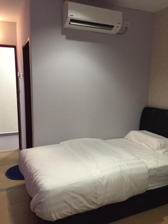 Postel nebo postele na pokoji v ubytování Tas Sakura Budget Hotel