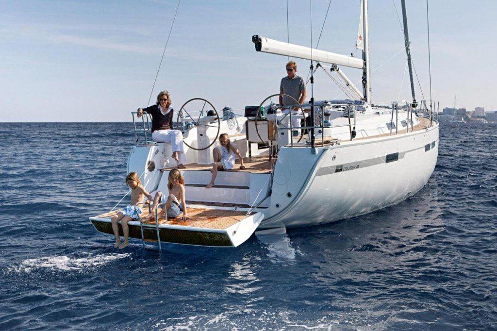 a group of people sitting on a boat in the water at Bavaria 45 Cruiser Prive huur incl. schipperservice in Sukošan