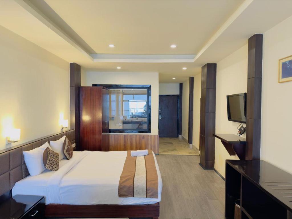 a hotel room with a bed and a television at Tara valley view in Gangtok