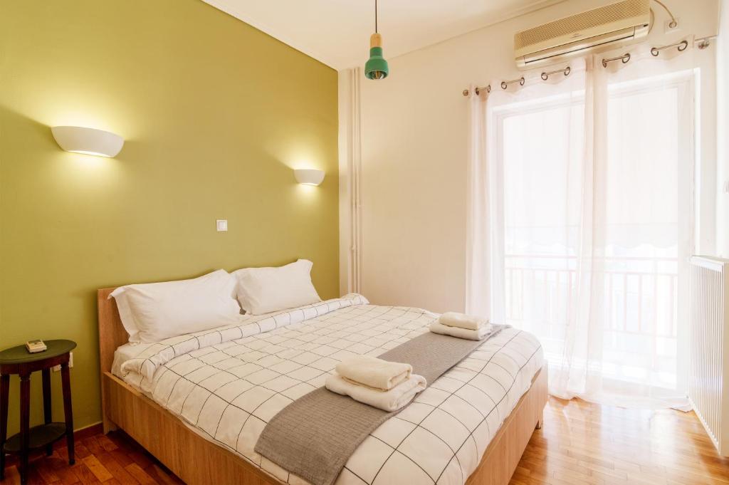a bedroom with a bed with towels on it at Cozy - Bright & New apart. - Downtown in Athens